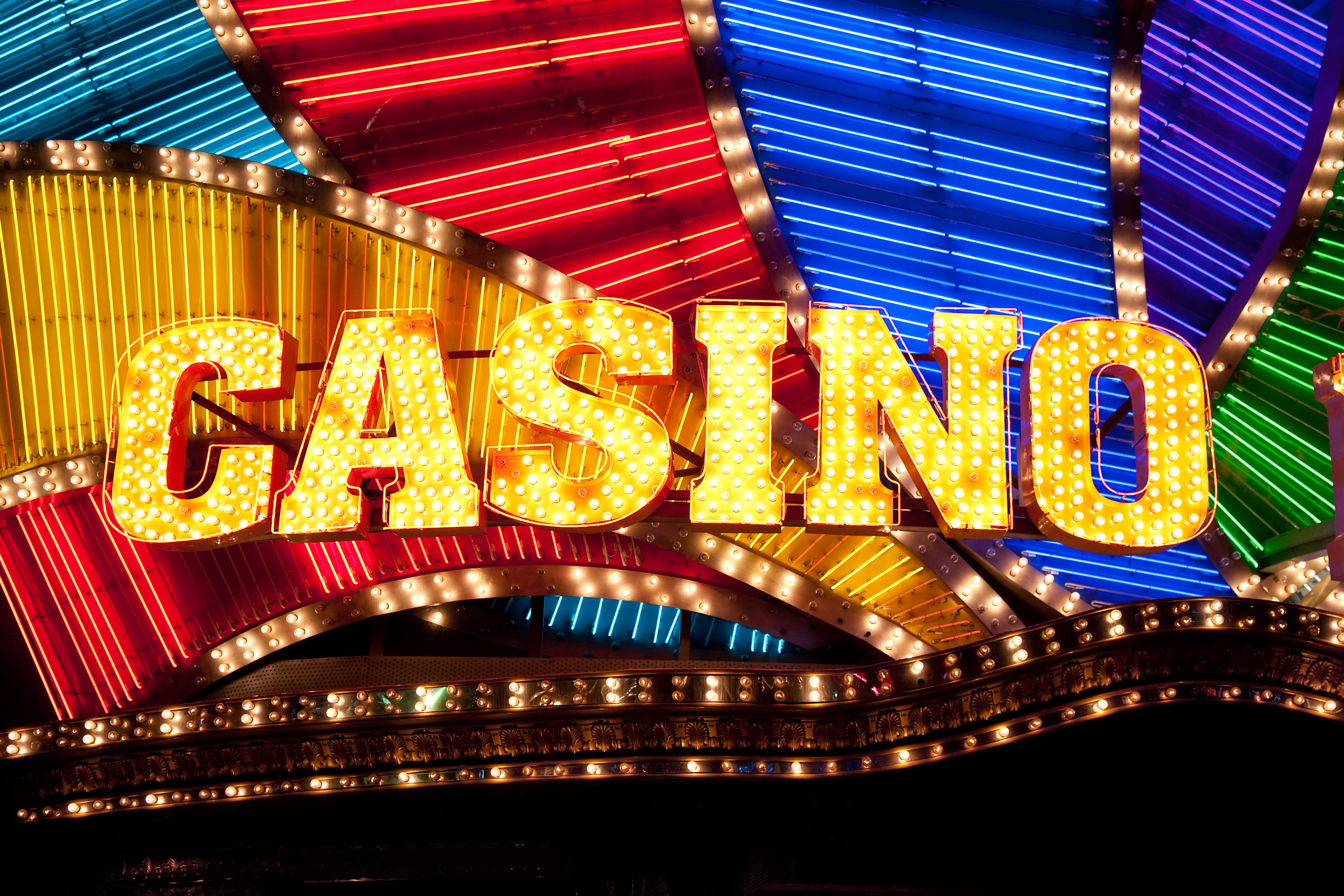 A dynamic graphic of cash flowing out of a casino game on a smartphone.